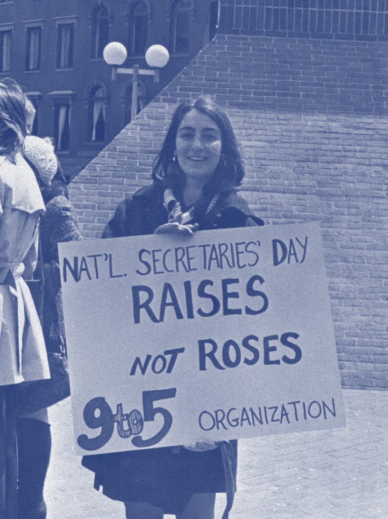 Woman holding sign reading 