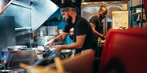 two men working in a restaurant kitchen